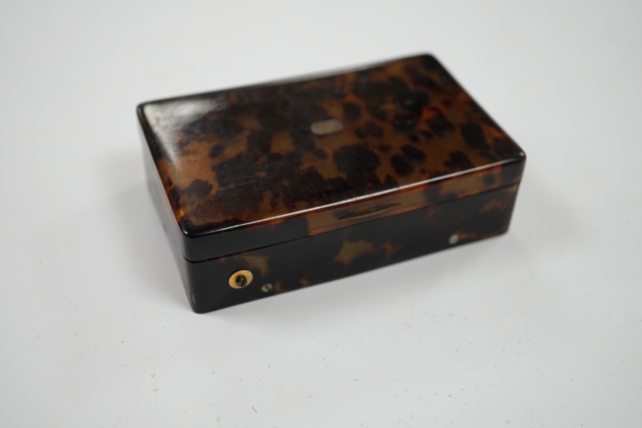 A 19th century tortoiseshell cased musical snuff box, 10cm. Condition - fair